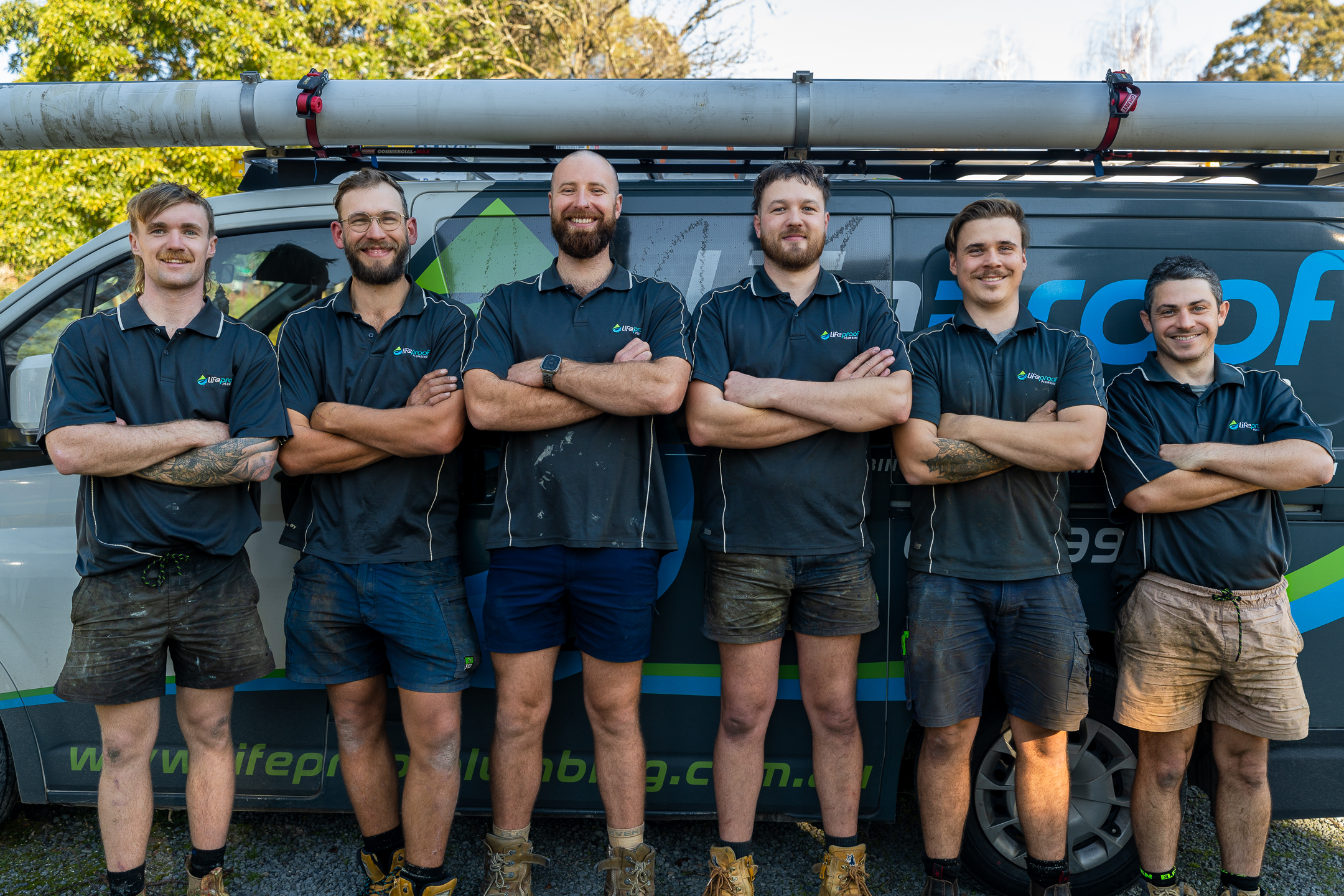 The LifeProof Roofing team standing in front of their work van